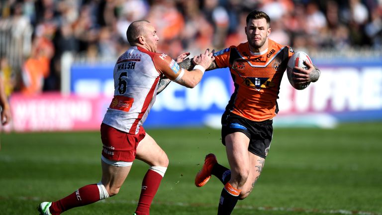 Zak Hardaker hands off Luke Walsh during the Betfred Super League match between Castleford Tigers and Catalan Dragons