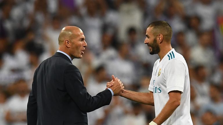 Real Madrid's French coach Zinedine Zidane (L) and Real Madrid's French forward Karim Benzema congratulate each other as they celebrate their Supercup afte