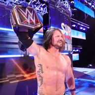 AJ Styles holds the WWE Championship belt aloft following his defeat of Jinder Mahal