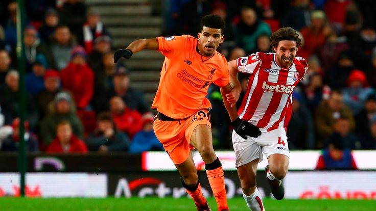 Liverpool's English striker Dominic Solanke (L) vies with Stoke City's Welsh midfielder Joe Allen during the English Premier League football match between 