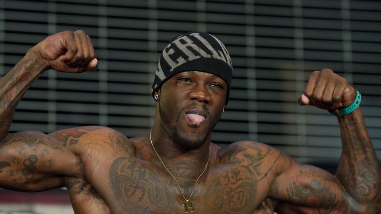 Boxer Deontay Wilder of the US flexes his muscles while weighing in at Barclay's Center January 15, 2016 in New York. 
Wilder is scheduled to fight Artur S