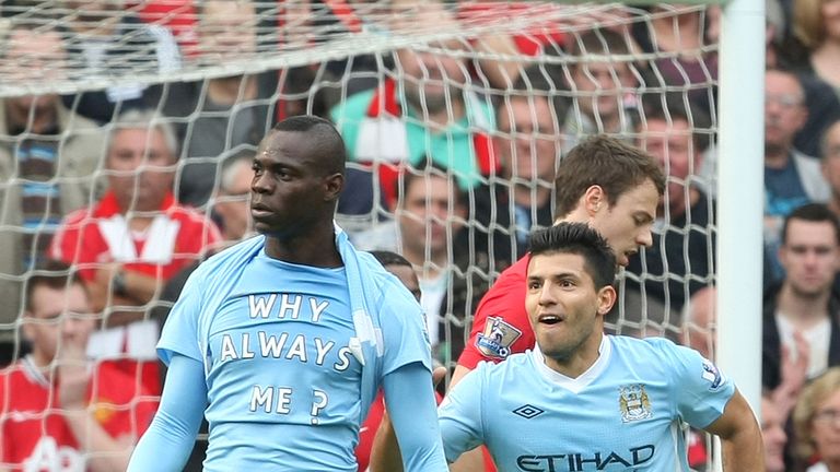 Mario Balotelli reveals his 'Why always me?' t-shirt after scoring in Manchester City's 6-1 win at Manchester United