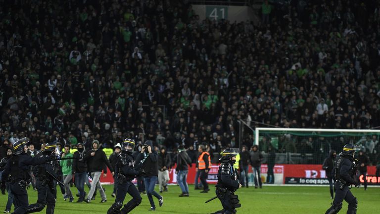 French riot police were called in as Saint-Etienne fans invaded the pitch at the Stade Geoffroy-Guichard