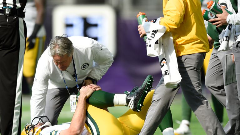 MINNEAPOLIS, MN - OCTOBER 15: Aaron Rodgers #12 of the Green Bay Packers clenches his right knee after being hit during the first quarter of the game again