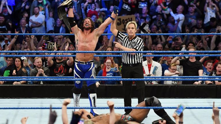 AJ Styles celebrates as the new WWE Champion