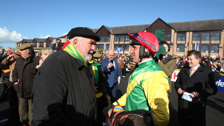 Owner Alan Potts speaks to jockey Robbie Power after riding Fox Norton to victory in the BoyleSports Champion Chase during day one of the Punchestown Festi