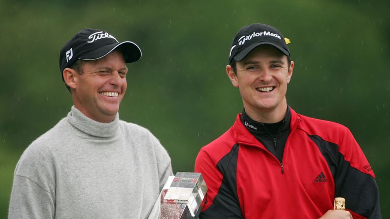 VIRGINIA WATER, UNITED KINGDOM - MAY 27:  Anders Hansen of Denmark jokes with Justin Rose of England as he holds the trophy following his victory in a play