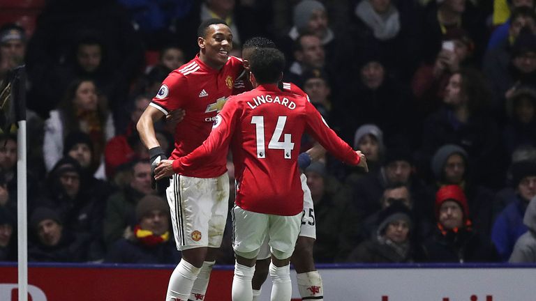 Anthony Martial celebrates with team-mates after extending Man Utd's lead at Vicarage Road