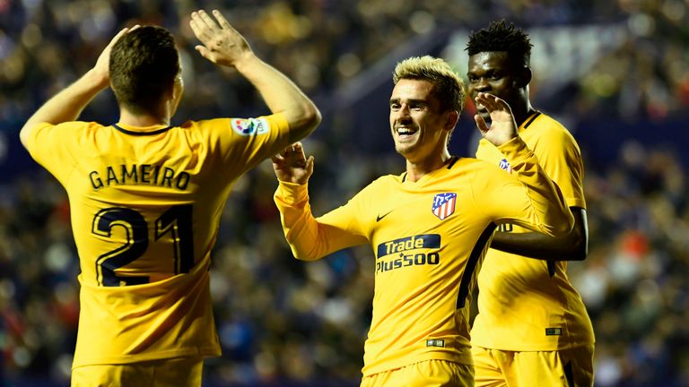 Atletico Madrid's French forward Antoine Griezmann (C) celebrates with Atletico Madrid's French forward Kevin Gameiro after scoring during the Spanish leag