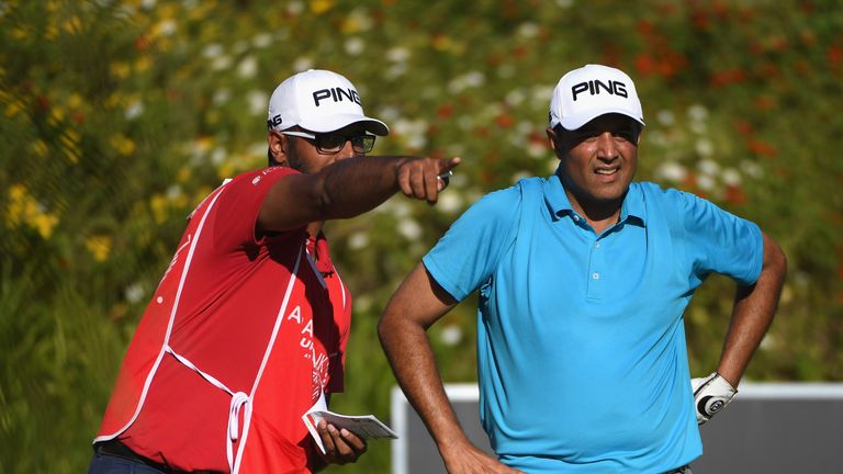 BEL OMBRE, MAURITIUS - NOVEMBER 30:  Arjun Atwal of India speaks with his caddie during day one of the AfrAsia Bank Mauritius Open at Heritage Golf Club on