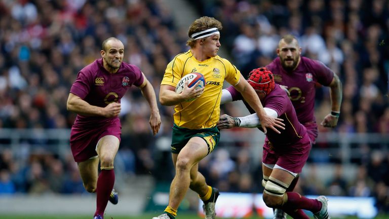 LONDON, ENGLAND - NOVEMBER 17:  Michael Hooper of Australia evades the tackles of Tom Johnson (right) and Charlie Sharples (left) during the QBE Internatio