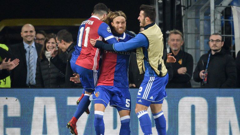 Basel's Swiss defender Michael Lang (C) celebrates with teammates after scoring a goal during the UEFA Champions League Group A football match between FC B