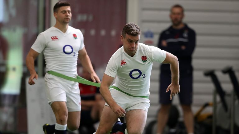 BAGSHOT, ENGLAND - MAY 27:  George Ford sprints as Ben Youngs holds the restraining band during the England training session held at Pennyhill Park on May 
