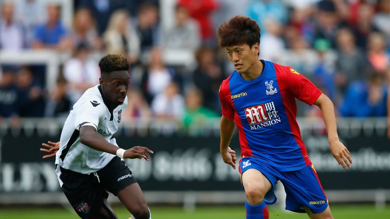 BROMLEY, ENGLAND - AUGUST 02:  Lee Chung-Yong of Palace battles with Blair Turgott of Bromley during the Pre Season Friendly match between Bromley Town FC 