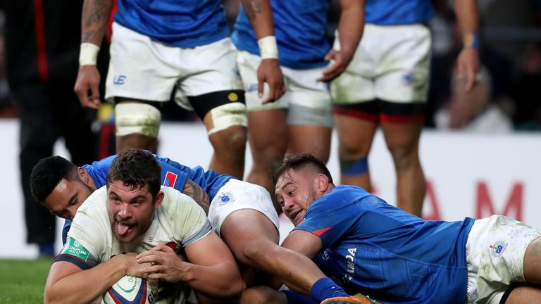 Charlie Ewels of England touches down for the third try while being tackled by Dwayne Polataivao of Samoa