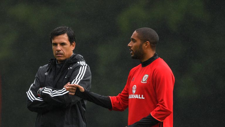 Wales manager Chris Coleman (left) chats with Ashley Williams at training