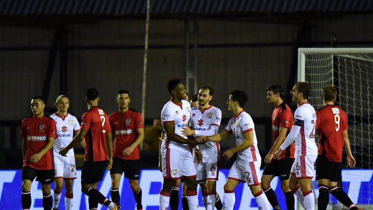 MK Dons' Chuks Aneke celebrates scoring his side's second goal of the game during the Emirates FA Cup, first round match at Ewen Fields, Hyde