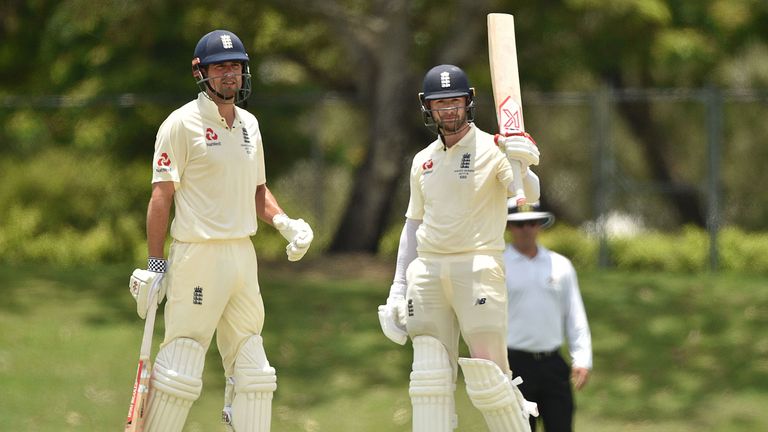 England opener Mark Stoneman (R) celebrates his 50 next to partner Alastair Cook (L) against Cricket Australia XI on the second day of a four-day Ashes tou