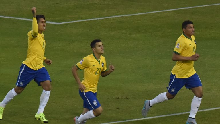 Brazil's defender Thiago Silva (R) celebrates with  Brazil's forward Roberto Firmino (L) and Brazil's midfielder Philippe Coutinho after scoring against Ve