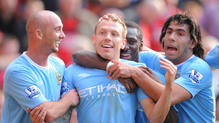 Manchester City's Welsh forward Craig Bellamy (2L) celebrates with team mates after scoring the third goal during the English Premier League football match