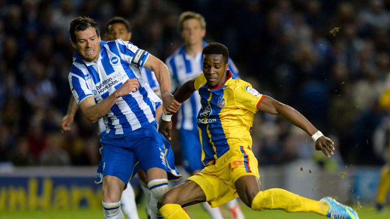 BRIGHTON, ENGLAND - MAY 13:  Wilfried Zaha of Crystal Palace shoots past Gordon Greer of Brighton & Hove Albion to score his second goal during the npower 