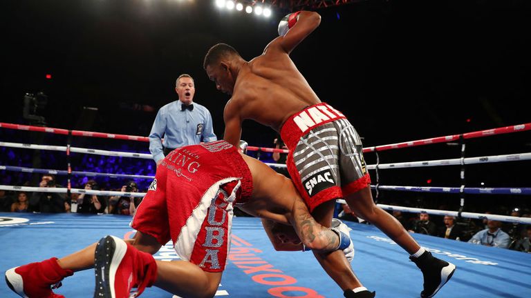 Daniel Jacobs and Luis Arias tumble to the mat as Arias grabs Jacobs leg in the first round during their Middleweight bout