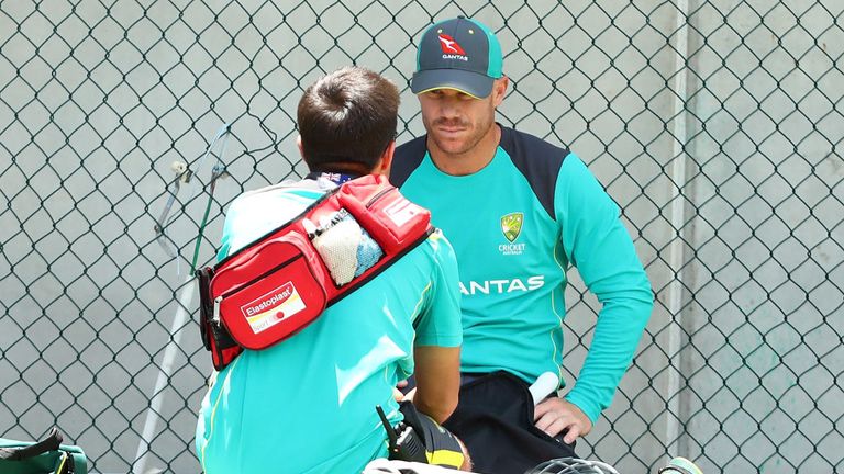 BRISBANE, AUSTRALIA - NOVEMBER 21:  David Warner talks to the team doctor during the Australian nets session at The Gabba on November 21, 2017 in Brisbane.