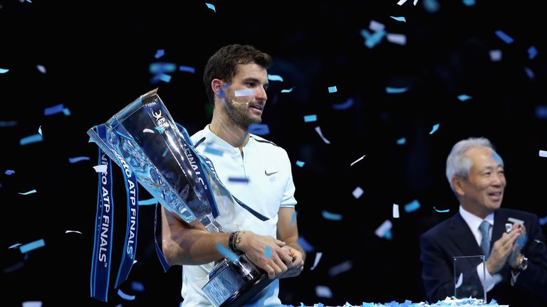 LONDON, ENGLAND - NOVEMBER 19:  Grigor Dimitrov of Bulgaria lifts the trophy as he celebrates victory following the singles final against David Goffin of B