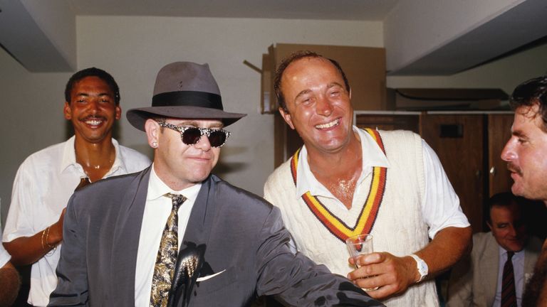 England's Phillip de Freitas (l) Phil Edmonds (c) & Allan Lamb (r) share a joke and champagne with Elton John after England had beaten Australia