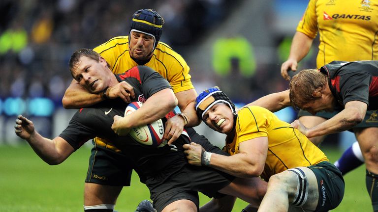 England's Hooker Dylan Hartley (L) gets tackled by Australia's Nathan Sharpe (TOP) and David Pocock (R) during the Autumn International rugby union match a