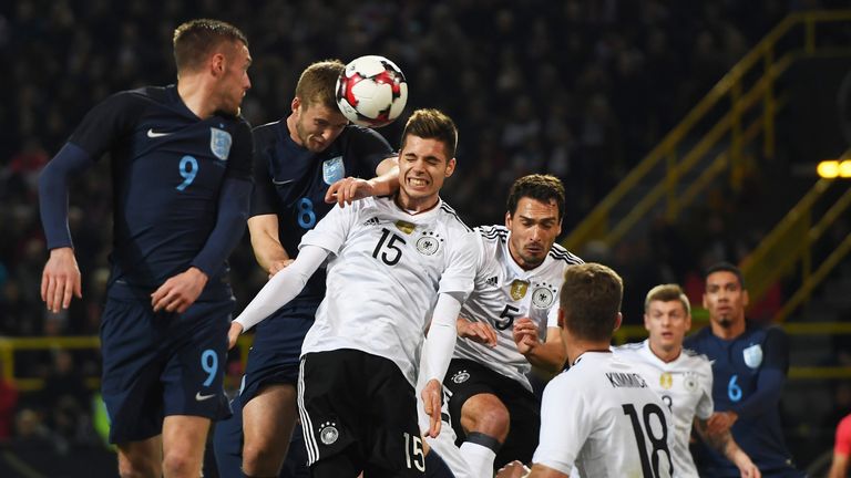 Eric Dier rises above Mats Hummels (c) and Julian Weigl during the friendly match between Germany and England at Dortmund's Signal Iduna Park in March