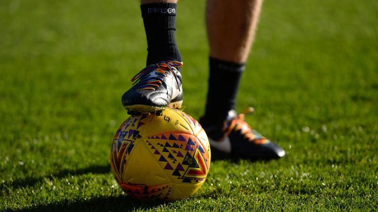 A player wears rainbow laces for the Stonewall campaign during the pre-match warm-up