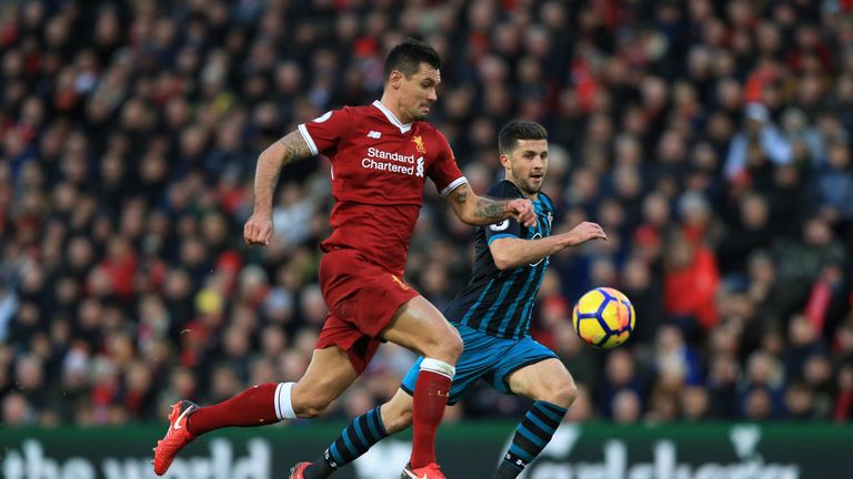 LIVERPOOL, ENGLAND - NOVEMBER 18:  Shane Long of Southampton and Dejan Lovren of Liverpool compete for the ball during the Premier League match between Liv