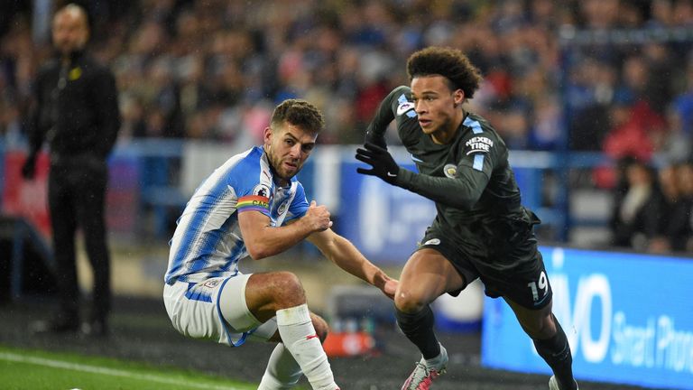 Leroy Sane (R) vies with Tommy Smith during the Premier League football match between Huddersfield and Manchester City