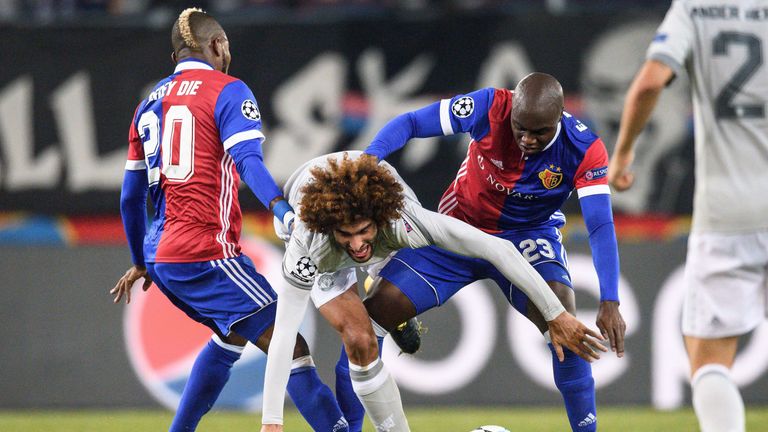 Marouane Fellaini vies for the ball with Basel's Geoffroy Serey Die (left) and  Eder Balanta
