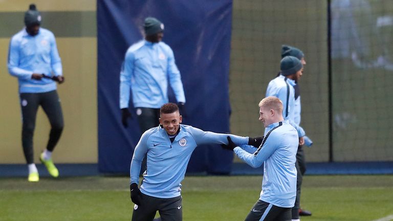 Gabriel Jesus and Kevin De Bruyne share a joke during training at the City Football Academy