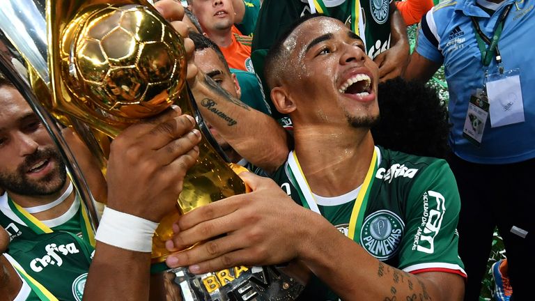 Palmeiras player Gabriel Jesus (R) holds up the trophy as he celebrates with teammates after winning the Brazilian championship football final match agains