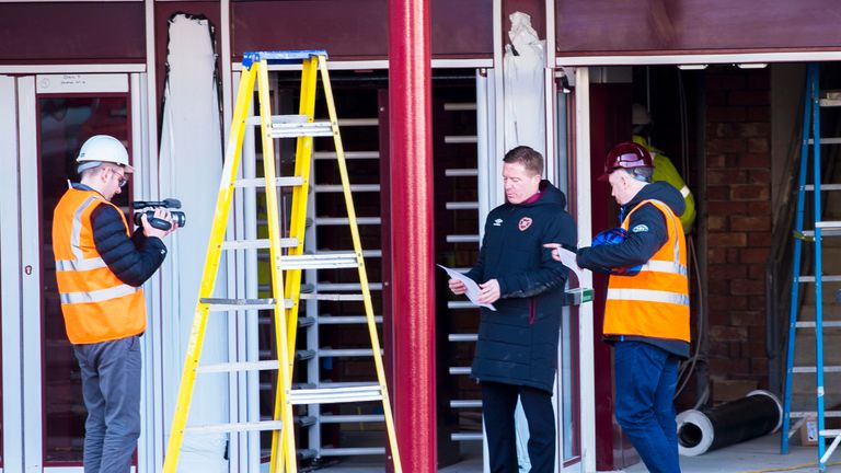 Hearts ambassador Gary Locke (2nd right) as work continues on the new stand at Tynecastle.