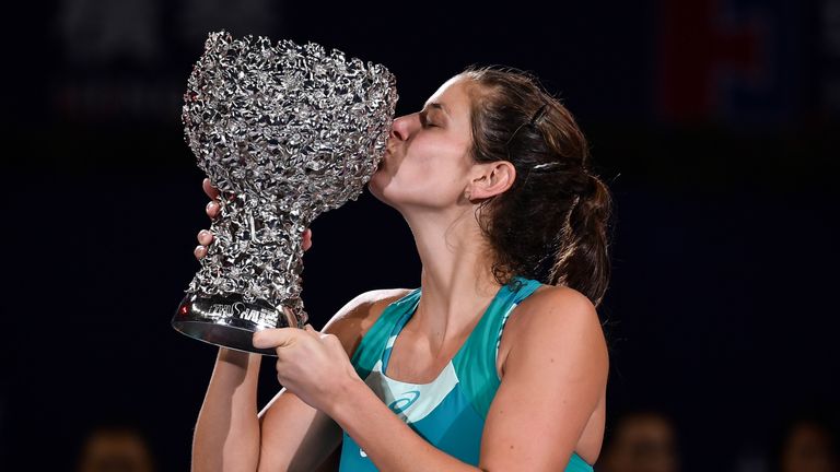 Julia Goerges of Germany kisses the trophy after her victory against Coco Vandeweghe of the US in the women's singles final at the Zhuhai Elite Trophy tenn