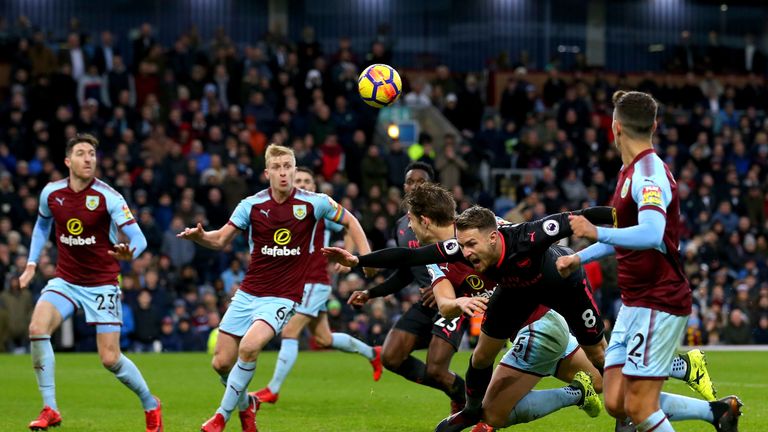 BURNLEY, ENGLAND - NOVEMBER 26:  James Tarkowski of Burnley fouls Aaron Ramsey of Arsenal which led to a penalty during the Premier League match between Bu