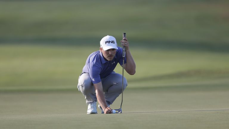 Austin Cook lines up a putt on the 16th green during the third round of The RSM Classic