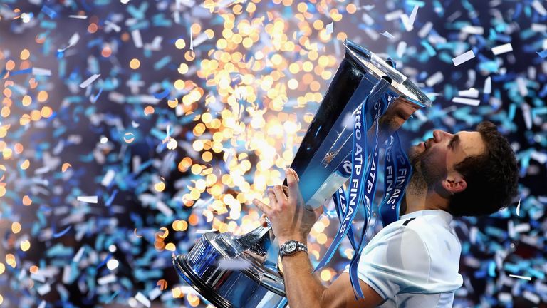 Grigor Dimitrov of Bulgaria kisses the trophy as he celebrates victory during the singles final against David Goffin