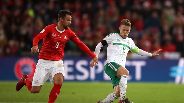 Switzerland's Haris Seferovic (left) and Northern Ireland's Steven Davis battle for the ball 