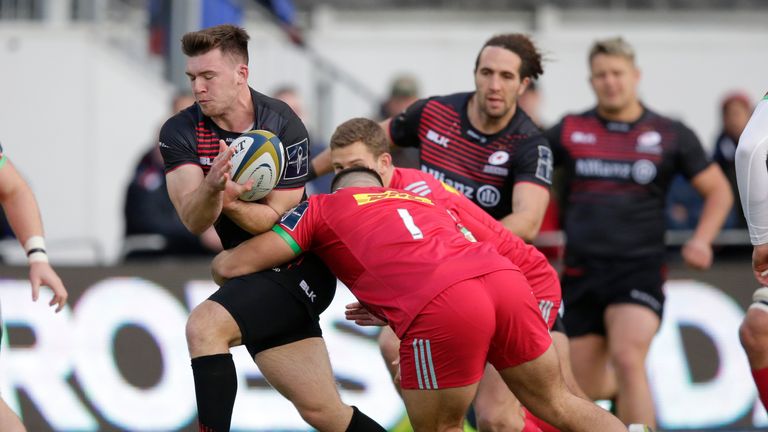 Matt Gallagher of Saracens is tackled by Lewis Boyce of Harlequins 