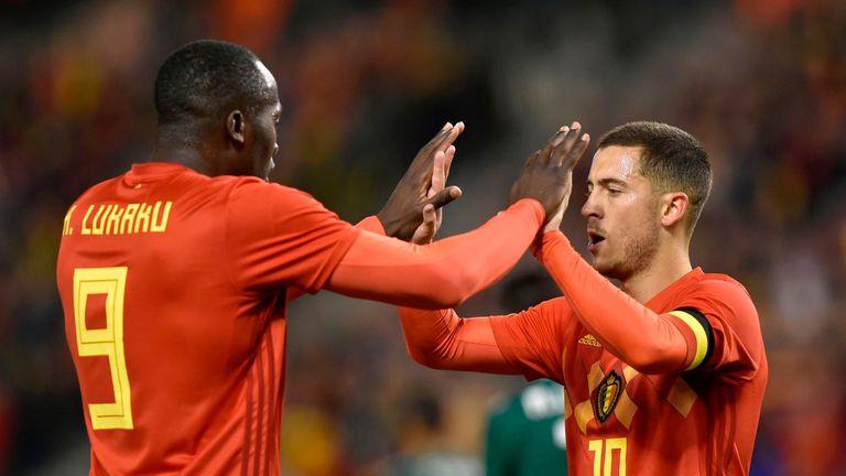 Belgium's midfielder Eden Hazard (R) celebrates with teammate Romelu Lukaku after scoring.