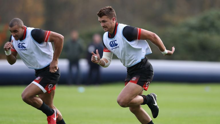 Henry Slade (R) sprints with his centre partner Jonathan Joseph during the England training session held at Pennyhill Park