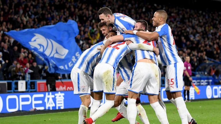 Huddersfield players celebrate after Nicolas Otamendi of Manchester City scored an own goal
