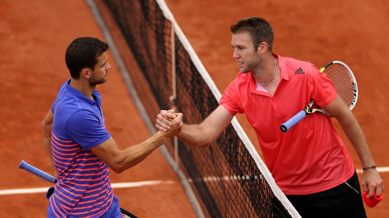 PARIS, FRANCE - MAY 26:  Jack Sock of the United States is congratulated on victory at the net by Grigor Dimitrov of Bulgaria after their Men's Singles mat