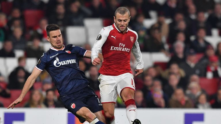 Arsenal midfielder Jack Wilshere (R) is tackled by Red Star Belgrade's midfielder Marko Gobeljic