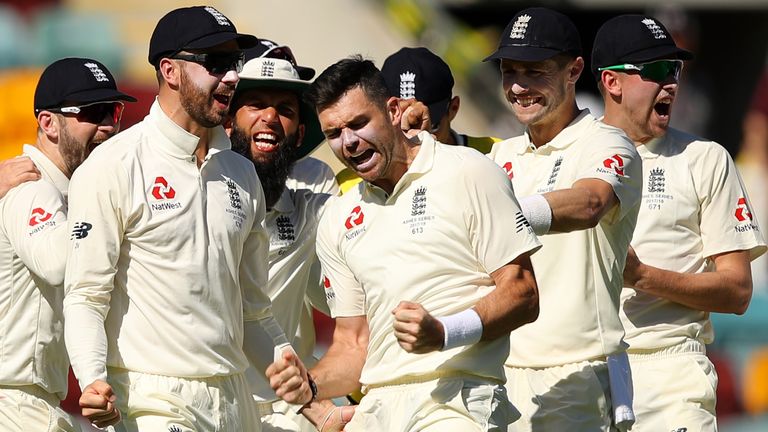 BRISBANE, AUSTRALIA - NOVEMBER 24:  James Anderson of England celebrates with team mates after a successful DRS appeal for the dismissal of Peter Handscomb
